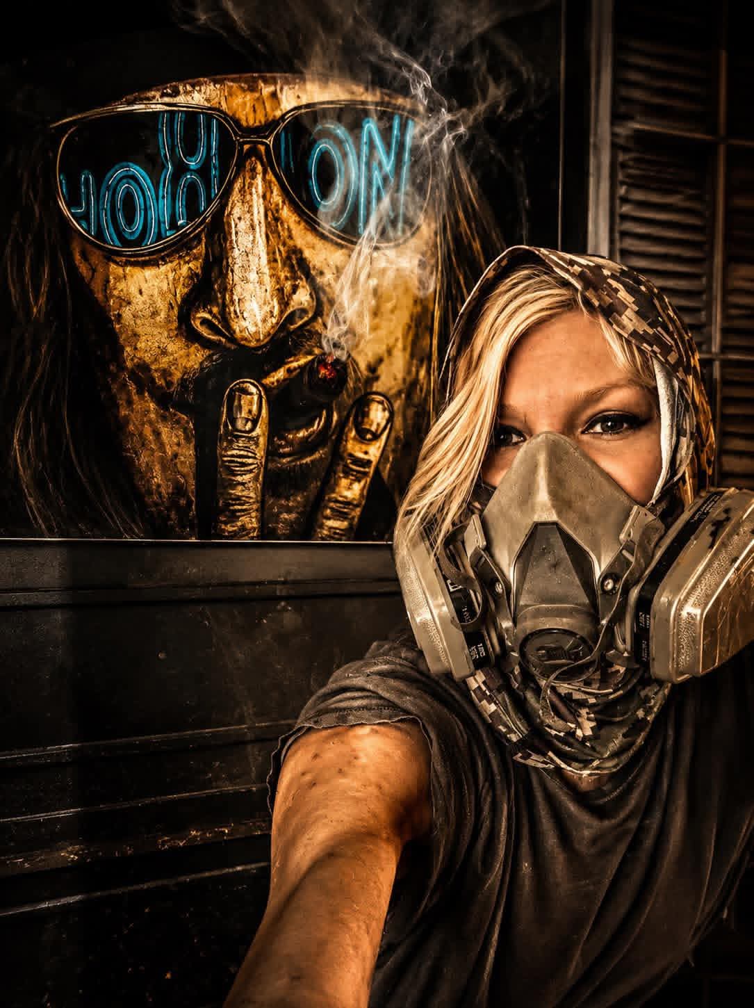 Amber, the artist behind Fire & Flow, in her studio wearing her respirator
